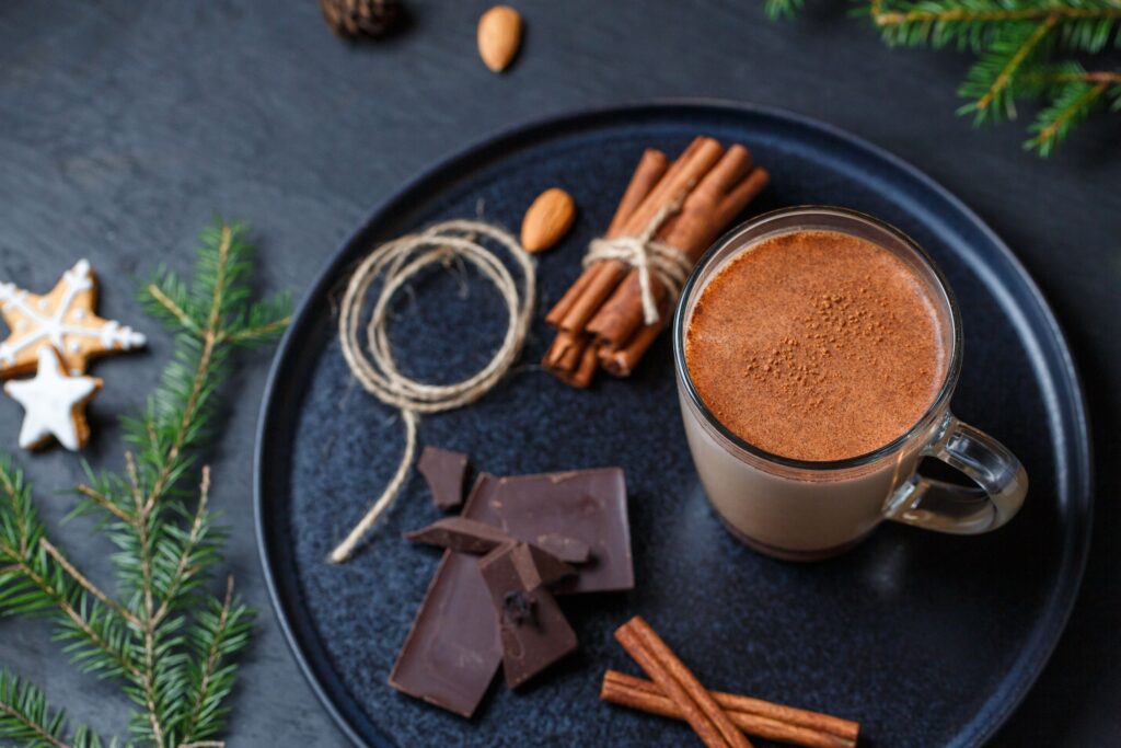 A steaming mug of jaggery hot chocolate topped with cocoa, a cozy winter drink made with natural sweetener
